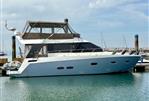 Sealine F46 - 2011 Sealine F46 yacht docked in a marina under a clear sky.