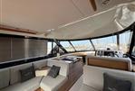 Sealine F46 - Luxurious interior of 2011 Sealine F46 yacht with modern seating and panoramic windows.
