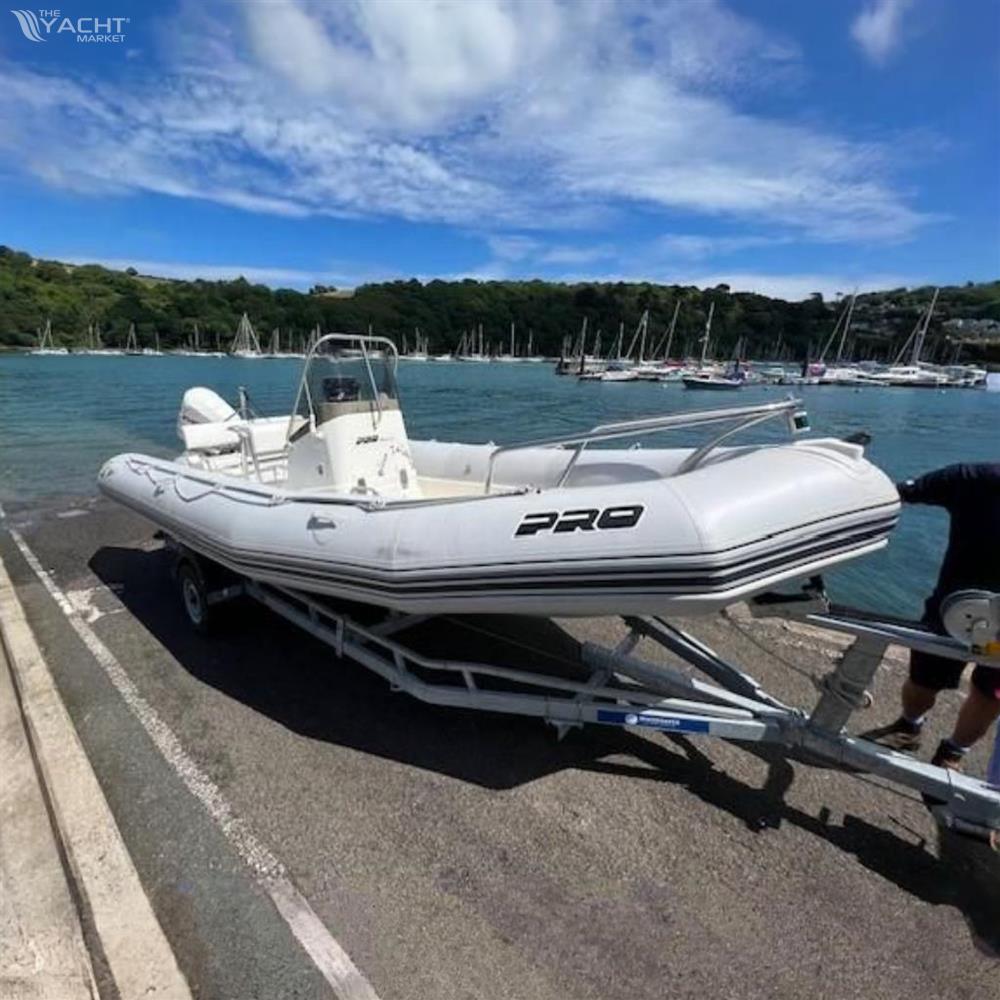 Zodiac Pro Open 650 - 2005 Zodiac Pro Open 650 boat on trailer by scenic waterfront.