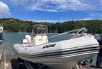 Zodiac Pro Open 650 - 2005 Zodiac Pro Open 650 boat on trailer by scenic waterfront.