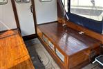 Lochin Fast Fisher - Interior of a 1996 Lochin Fast Fisher boat with polished wooden benches and nautical decor.