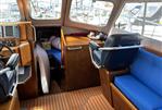 Lochin Fast Fisher - Interior of a 1996 Lochin Fast Fisher boat with blue seating and wooden accents.