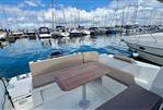 Beneteau Antares 8 - 2019 Beneteau Antares 8 boat interior with seating and table, docked in a marina.