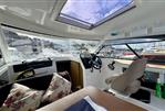 Beneteau Antares 8 - Interior of 2019 Beneteau Antares 8 boat with steering wheel and seating area.