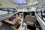 Beneteau Antares 8 - Interior of 2019 Beneteau Antares 8 boat with helm, seating, and table.