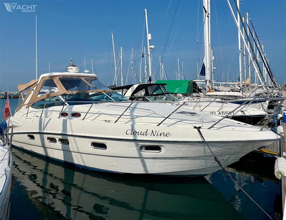 Sealine S38 - 2006 Sealine S38 yacht named &quot;Cloud Nine&quot; docked in a marina.