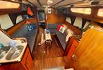 Jeanneau Melody 34 - Interior of 1981 Jeanneau Melody sailboat with cozy seating and wooden finishes.