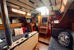 Jeanneau Melody 34 - Interior of 1981 Jeanneau Melody sailboat with cozy seating and nautical decor.