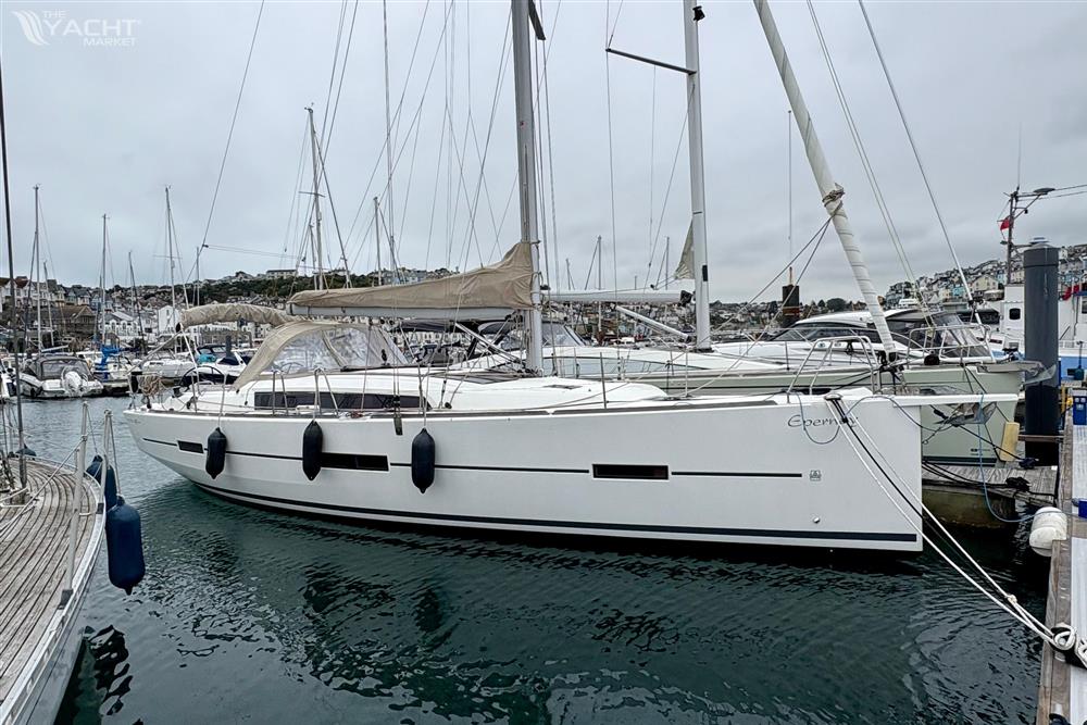 Dufour 412 Grand Large - 2018 Dufour 412 Grand Large sailboat docked in a marina, overcast sky.