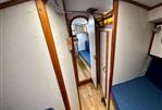 Moody 30 - Interior of a 1978 Moody 30 sailboat with wooden trim and blue seating.