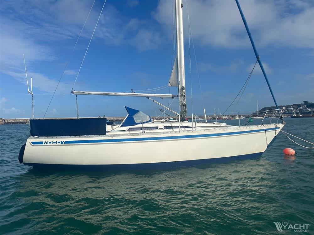 Moody 34 - 1985 Moody 34 sailboat anchored in calm waters under a clear blue sky.