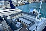 Jeanneau Cap Camarat 6.5 WA - 2019 Jeanneau Cap Camarat 6.5 WA boat interior with seating and motor, docked at marina.