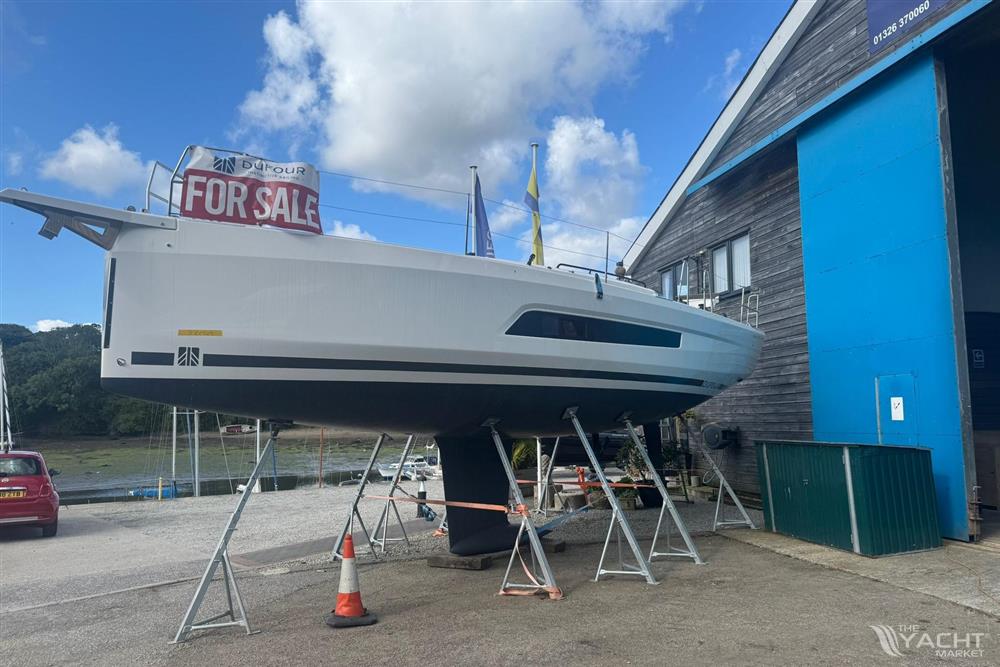 Dufour 37 - 2025 Dufour 37 yacht for sale, elevated on stands near a blue building.