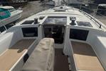 Dufour 37 - 2025 Dufour 37 yacht deck with seating and winches, docked at marina.