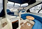 Gobbi 345SC - Interior of 2005 Gobbi 345SC yacht with blue seating and wooden table.