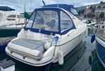 Gobbi 345SC - 2005 Gobbi 345SC boat docked in marina, featuring blue canopy and inflatable dinghy.