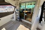 Jeanneau Merry Fisher 925 - 2008 Jeanneau Merry Fisher 925 boat interior with sliding glass door and wooden flooring.