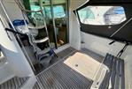 Jeanneau Merry Fisher 925 - 2008 Jeanneau Merry Fisher 925 boat interior with wooden deck and seating area.