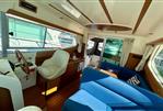 Jeanneau Merry Fisher 925 - Interior of 2008 Jeanneau Merry Fisher 925 boat with blue seating and helm station.