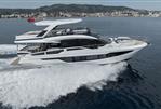 Galeon 640 Fly - 2023 Galeon 640 Fly yacht cruising on open water, scenic coastal backdrop.
