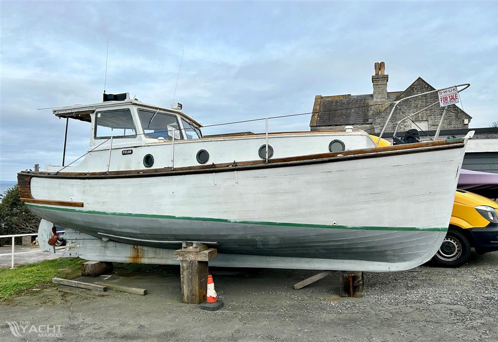 Classic James Caddy Motor Cruiser - 1956 Classic James Caddy Motor Cruiser on dry dock, showcasing vintage design.
