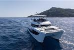Aquila 46 Yacht - Aquila 46 Yacht 2026 cruising on open sea near a scenic coastline.