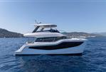 Aquila 46 Yacht - 2026 Aquila 46 Yacht cruising on blue ocean with scenic coastal backdrop.