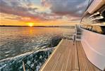 Fairline Squadron 58 - 2024 Fairline Squadron 58 yacht cruising at sunset, showcasing elegant deck design.