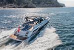 Fairline Targa 50 Open - 2025 Fairline Targa 50 Open yacht cruising on the ocean near rocky coastline.