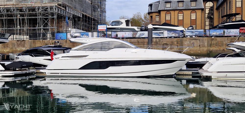 Fairline Targa 45 Open - 2025 Fairline Targa 45 Open yacht docked in a marina, reflecting on calm water.