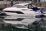 Fairline Targa 45 GT - 2025 Fairline Targa 45 GT luxury yacht docked in marina, reflecting on water.