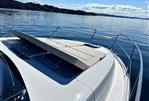 Fairline Targa 45 GT - 2025 Fairline Targa 45 GT yacht on calm water, featuring sleek design and sunbed.