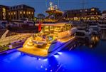 Fairline Squadron 58 - Luxurious 2025 Fairline Squadron 58 yacht illuminated at night in a marina.