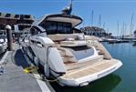 Fairline Targa 45 GT - 2022 Fairline Targa 45 GT yacht docked at marina under clear blue sky.