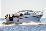 Nimbus 305 Drophead - 2026 Nimbus 305 Drophead cruising on open water with passengers, Swedish flag visible.