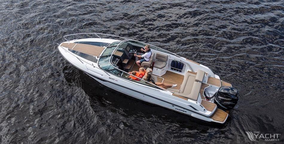 Flipper 800 DC - 2026 Flipper 800 DC boat cruising on water with passengers relaxing onboard.