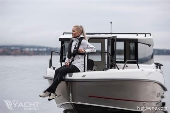 Falcon C7 - Woman sitting on 2026 Falcon C7 boat, enjoying a serene water view.