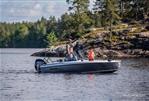 Falcon BRs 4 - 2026 Falcon BRs 4 boat on scenic lake with rocky shoreline and trees.