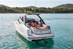 Fairline F//Line 33 - 2026 Fairline F//Line 33 yacht cruising on serene waters near a forested shoreline.