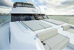 Aquila 70 Luxury - Aquila 70 Luxury yacht 2026 model on calm water under cloudy sky.