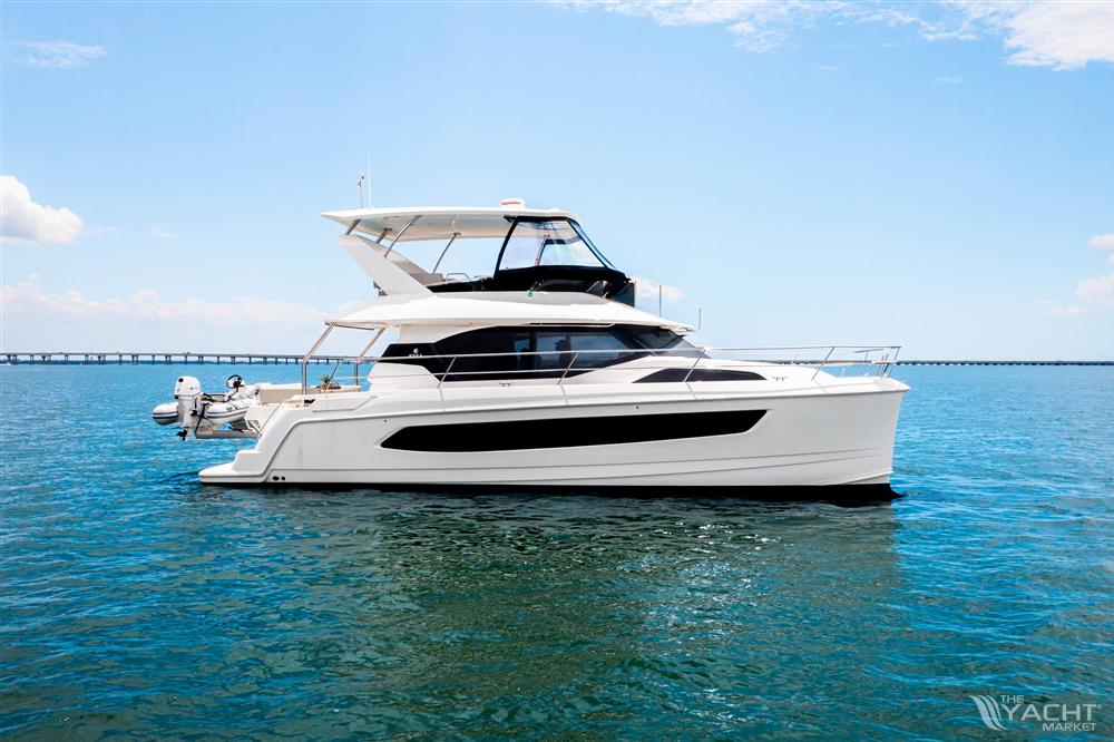 Aquila 44 Yacht - Aquila 44 Yacht 2026 on calm blue water under a clear sky.