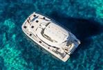 Aquila 44 Yacht - Aquila 44 Yacht 2026 cruising on clear turquoise waters, aerial view.
