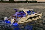 Aquila 36 Sport - 2026 Aquila 36 Sport yacht cruising with illuminated blue lights at sunset.