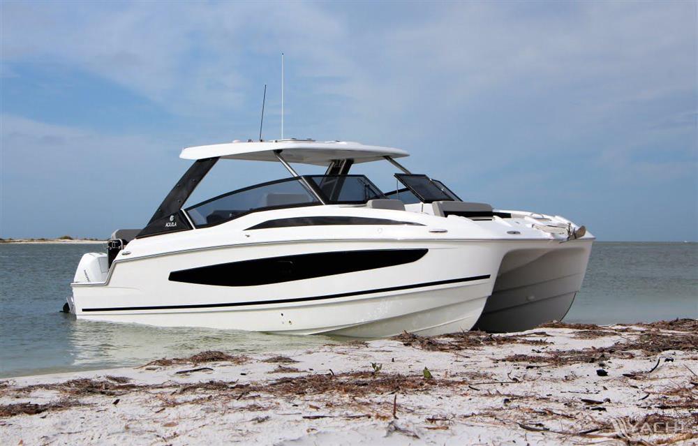 Aquila 32 Sport - 2026 Aquila 32 Sport boat on sandy beach with ocean backdrop.