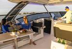 Aquila 32 Sport - 2026 Aquila 32 Sport yacht interior with people relaxing and enjoying a meal.