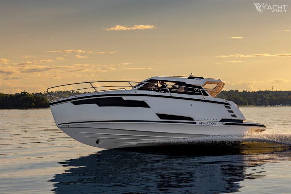 Aquador 300 HT - 2026 Aquador 300 HT cruising on calm water at sunset.