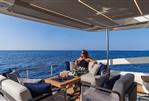 Absolute Navetta 53 - Woman relaxing on Absolute Navetta 53 yacht, 2026 model, with ocean view.