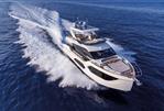 Absolute 60 Fly - Luxurious 2026 Absolute 60 Fly yacht cruising swiftly on open blue sea.