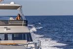 Absolute 56 FLY - 2026 Absolute 56 FLY yacht cruising on open sea with person enjoying the view.