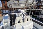 Galeon Galia 770 Sundeck - 2022 Galeon Galia 770 Sundeck boat docked at a marina with modern architecture.